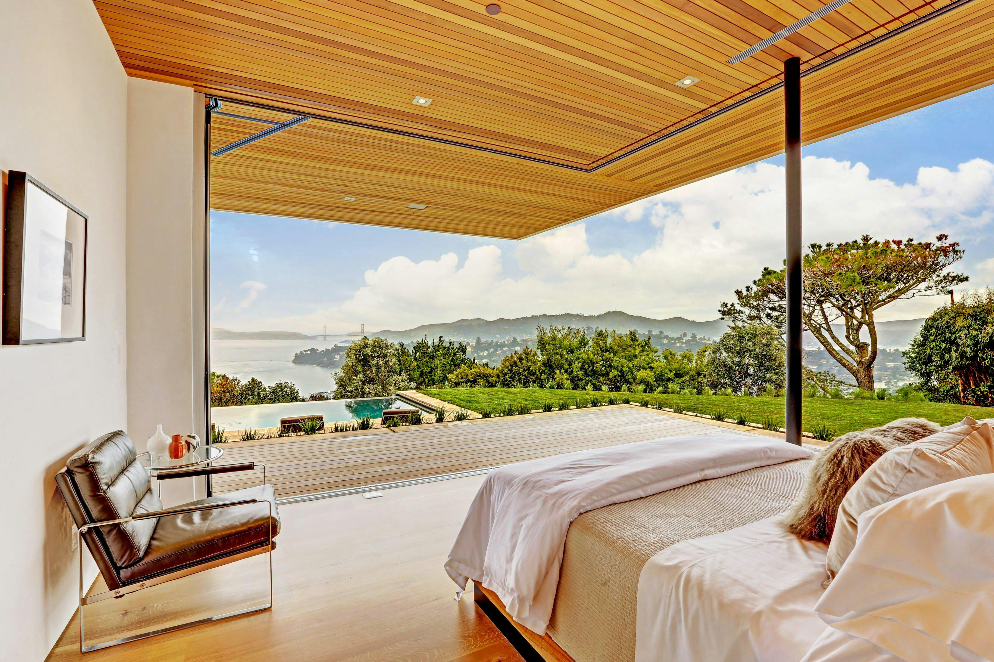 opening-glass-walls-in-bedroom-providing-ocean-view