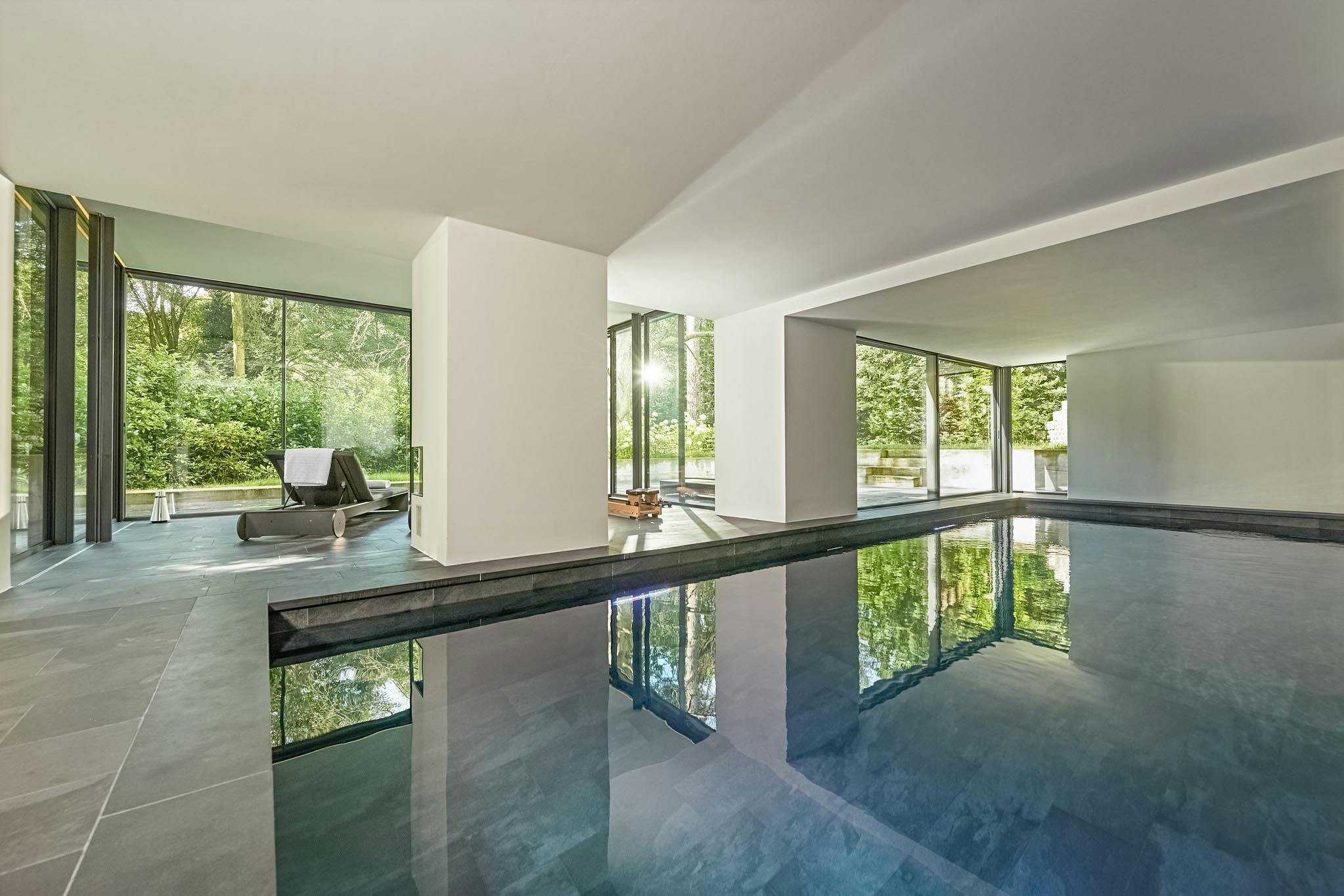 floor to ceiling cero minimal sliding glass walls in pool house