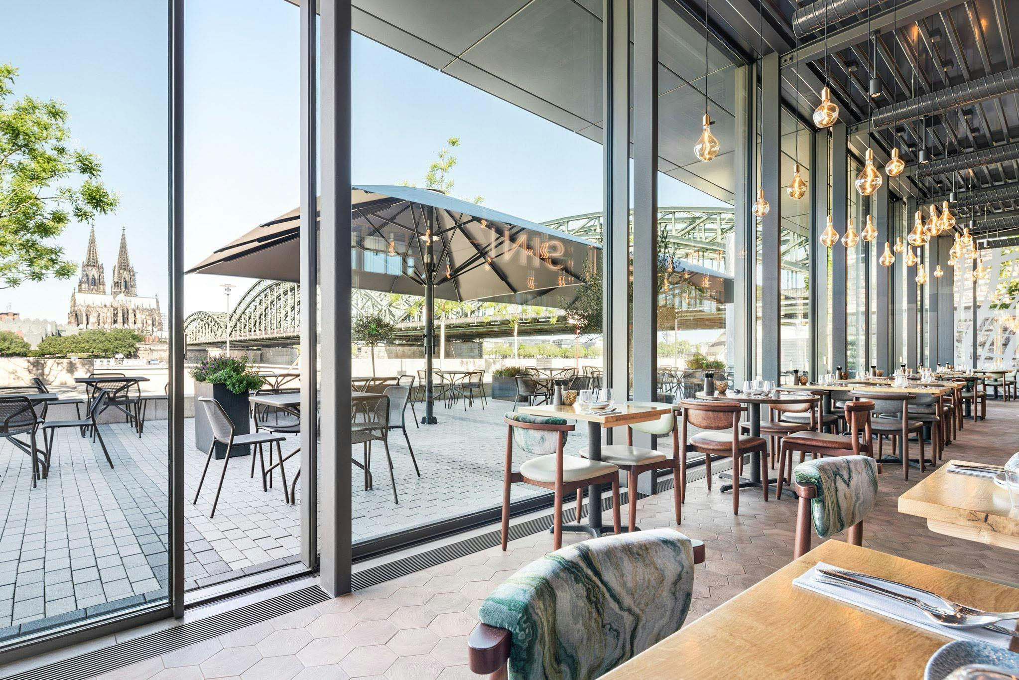 restaurant spaces designed with minimal sliding glass walls for fresh air and daylight
