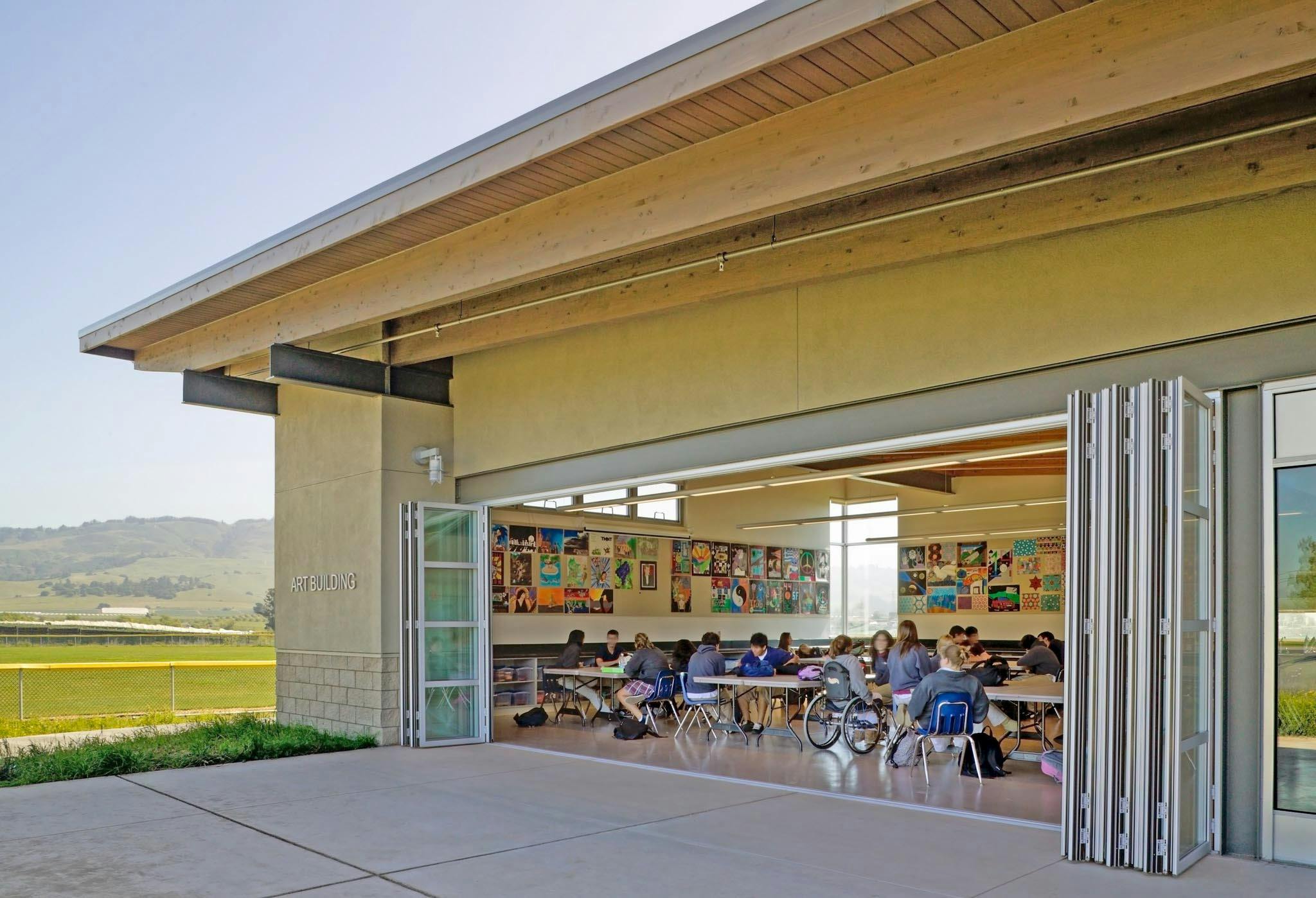high school classroom with large oping folding wall letting in fresh air and daylight