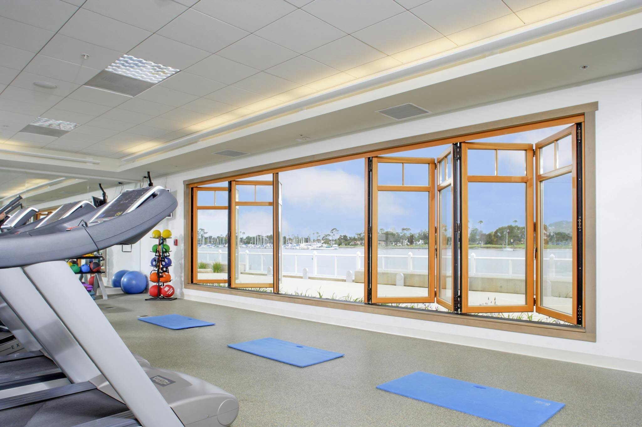 fitness center design with folding glass wall for fresh air