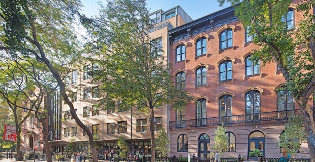 historic brownstones in NYC with modern school design with folding glass walls
