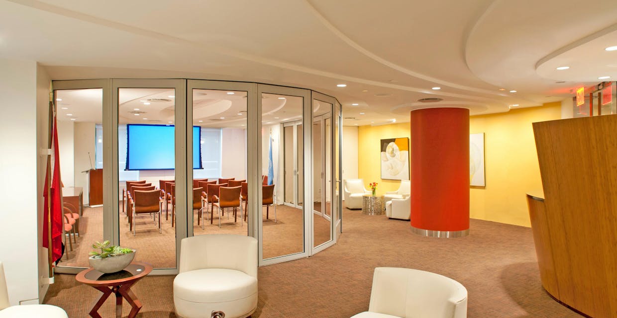 waiting room with segmented curve sliding door system creates flexible reconfiguarable office space