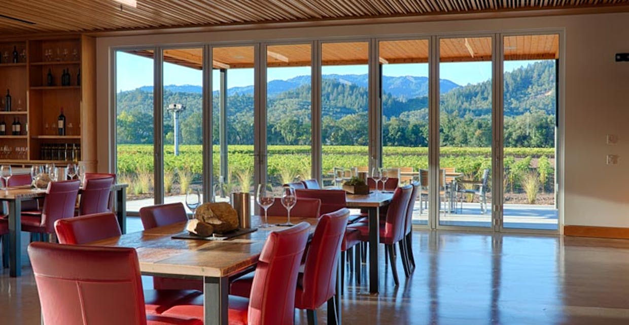 winery interior with commercial glass walls brings the vineyard outside in  