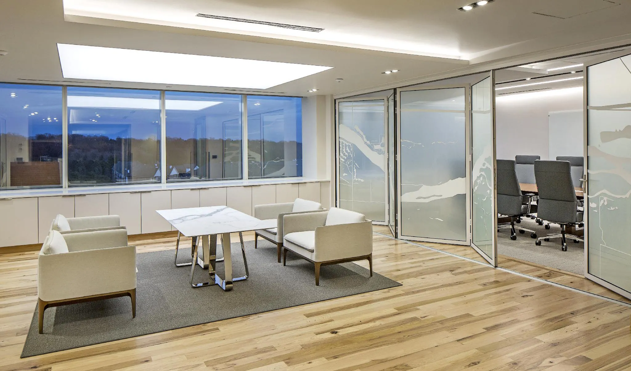 folding interior glass wall system in law office for flexibility between conference room and lobby
