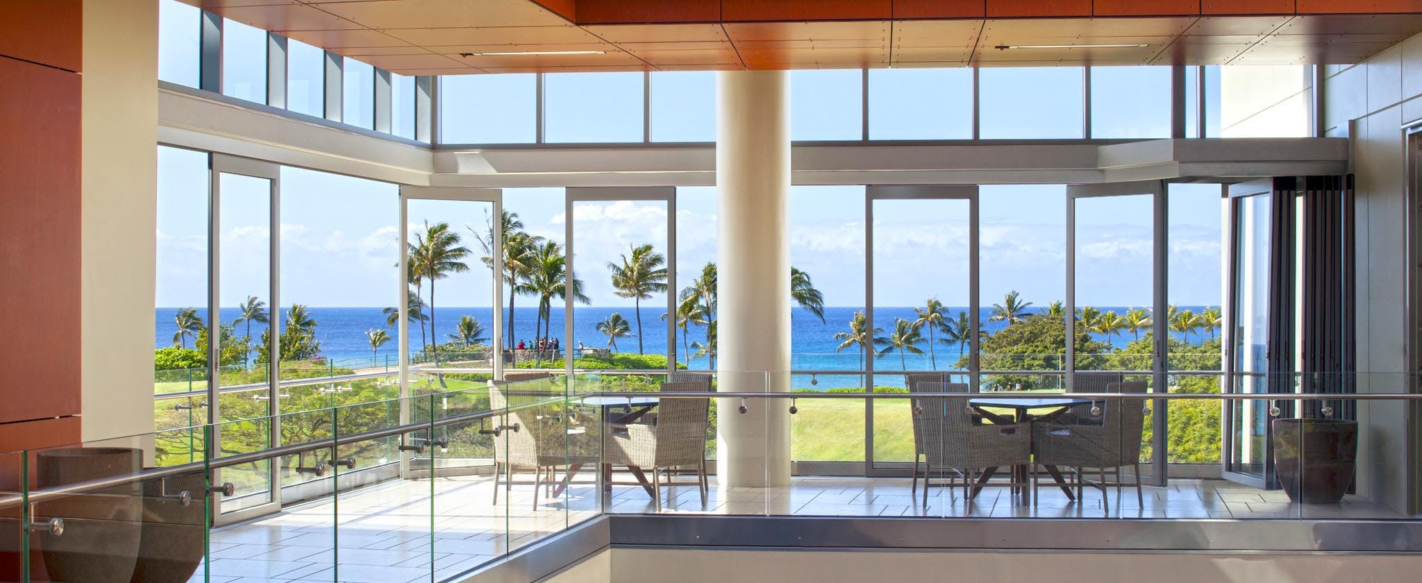 Commercial moveable glass walls - Ocean view floor with multiple opening sliding glass doors